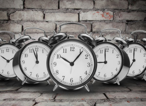 alarm clocks on brick wall