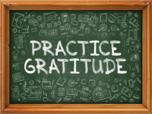 Practice Gratitude on Green Chalkboard.